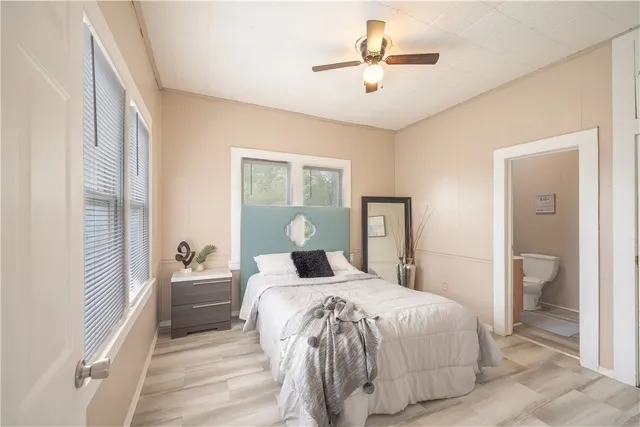 a bedroom with a large bed and a chandelier