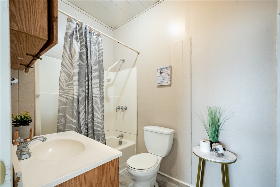 504 East 5th Street Alice, TX 78332 - Photo 7 of 12 a bathroom with a sink toilet and shower