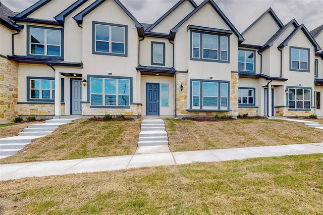 a front view of residential houses with yard