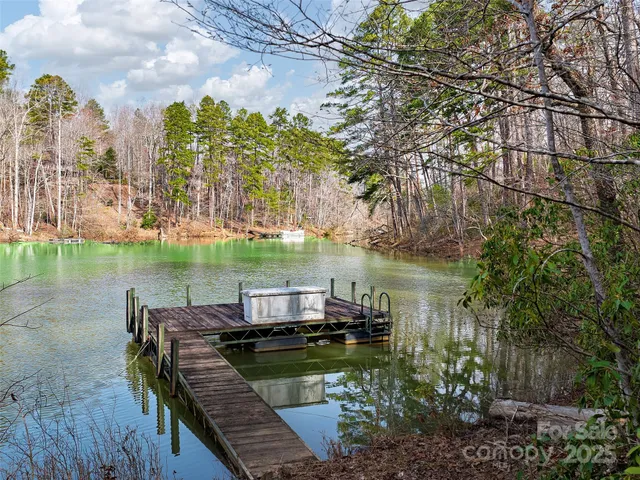 a view of a lake from a balcony with outdoor seating
