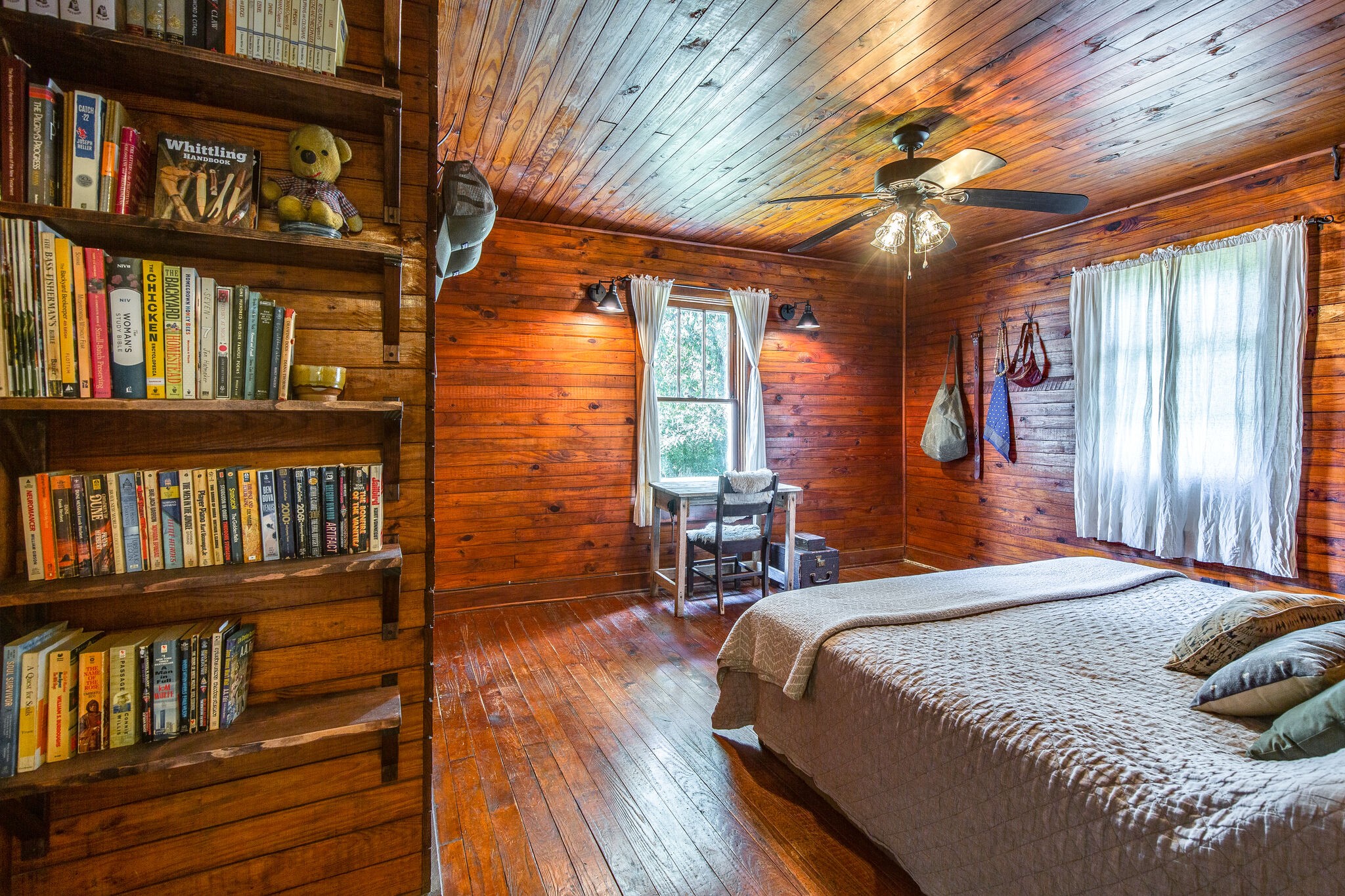 10221 Ed Lyell Road Lyles, TN 37098 - Photo 14 of 27 a bedroom with a bed wooden floor and book shelf