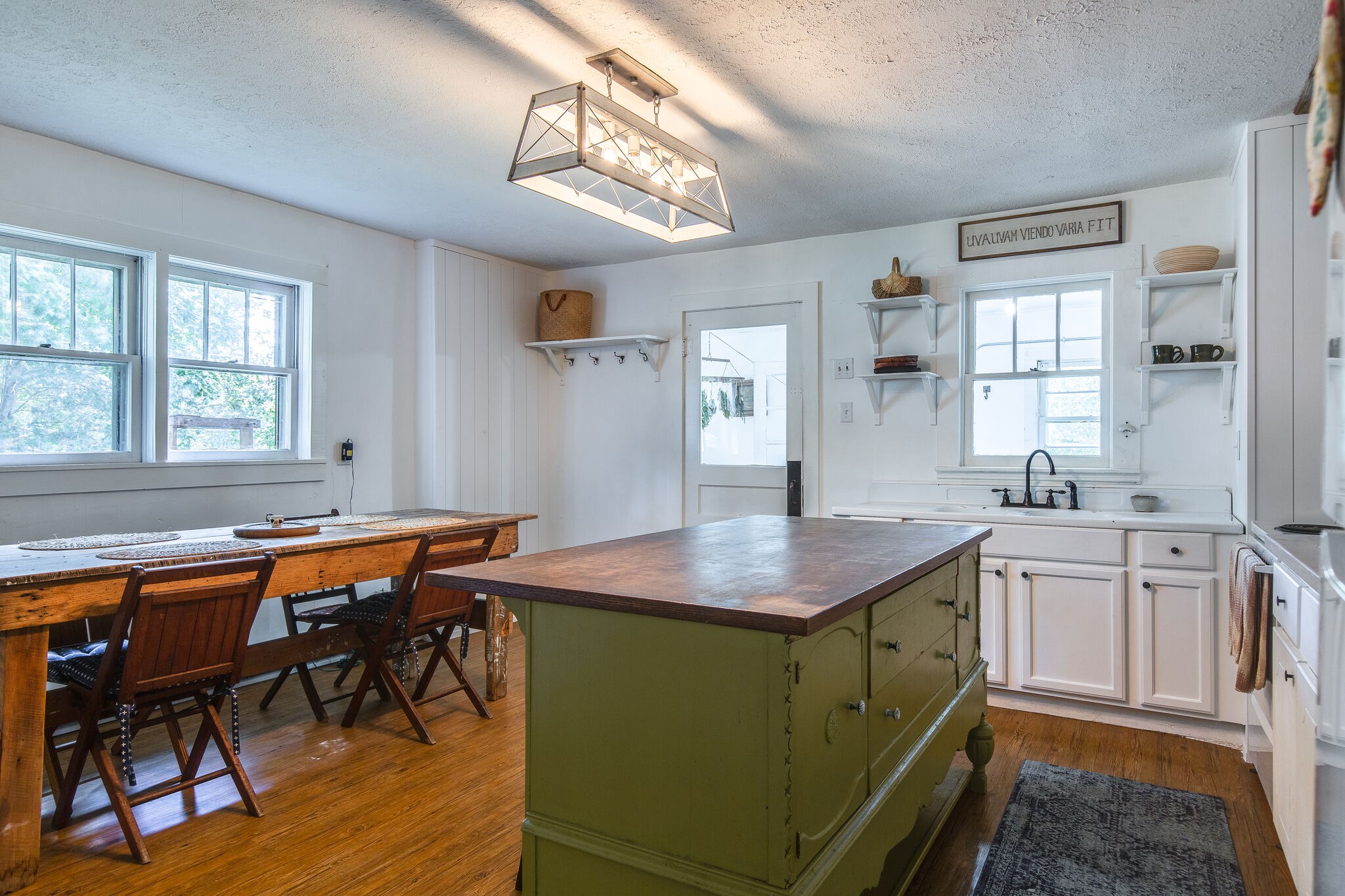 10221 Ed Lyell Road Lyles, TN 37098 - Photo 6 of 27 a dining hall with stainless steel appliances granite countertop a sink dishwasher and cabinets with wooden floor