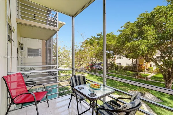 a view of a chairs and table in the balcony