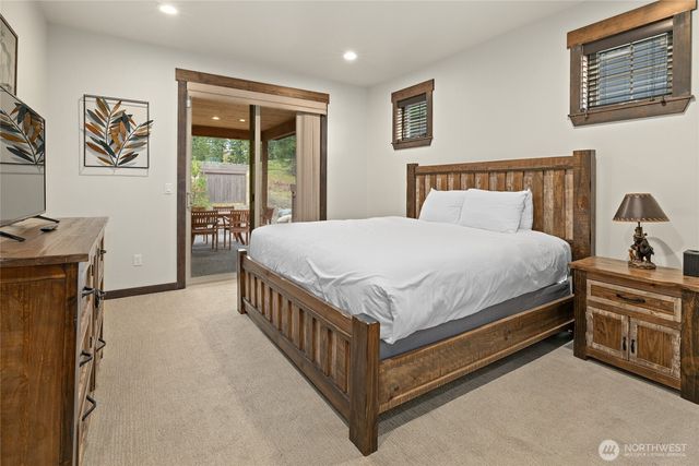a bed sitting in a bedroom next to a window