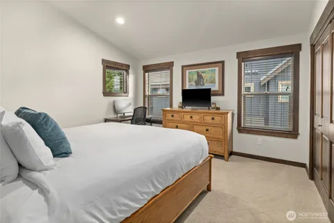 a bedroom with a bed and a television