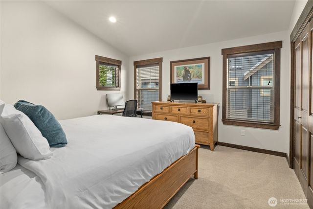 a bedroom with a bed and a television