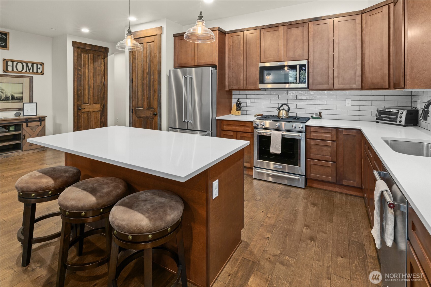 19 Big Hill Drive Cle Elum, WA 98922 - Photo 9 of 38 a kitchen with kitchen island a stove a sink a refrigerator with a dining table and chairs