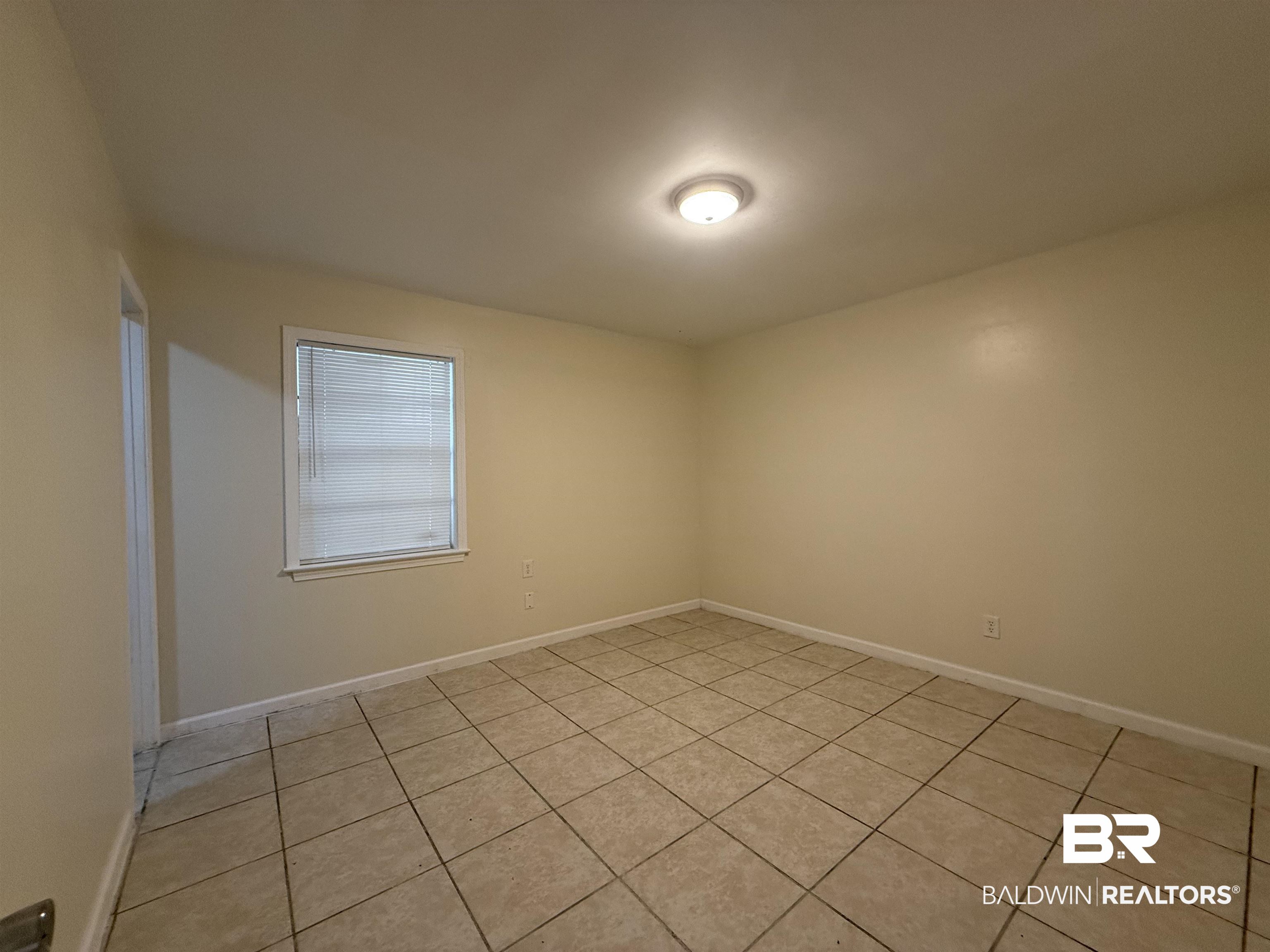 320 E Street Prichard, AL 36610 - Photo 9 of 16 Spare room featuring light tile patterned flooring