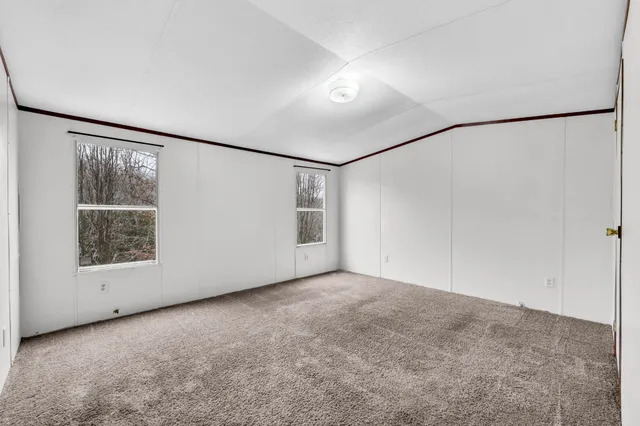 an empty room with a empty space and windows