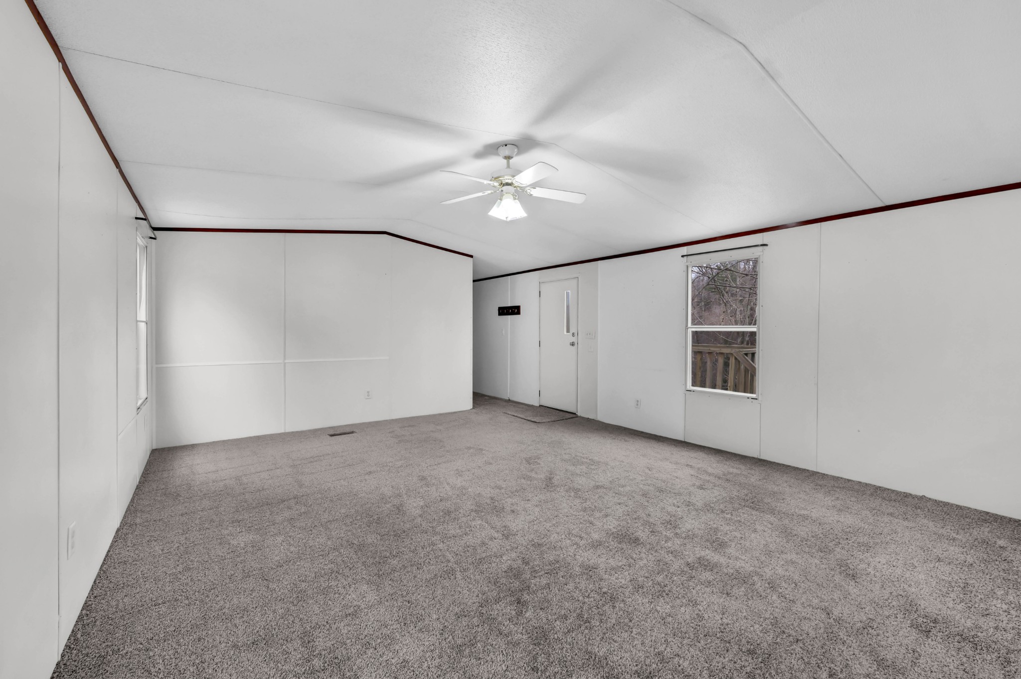 3845 Wickham Road Palmyra, TN 37142 - Photo 7 of 25 a view of a big room with ceiling fan and refrigerator