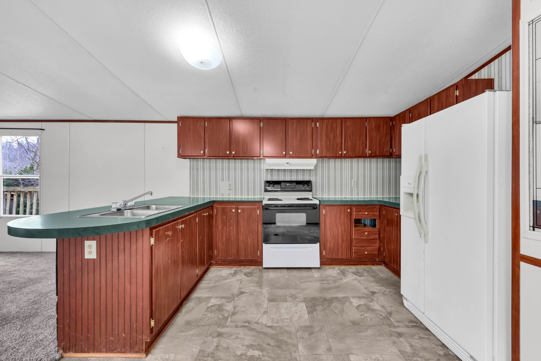 3845 Wickham Road Palmyra, TN 37142 - Photo 9 of 25 a kitchen with stainless steel appliances granite countertop a stove a sink and a refrigerator