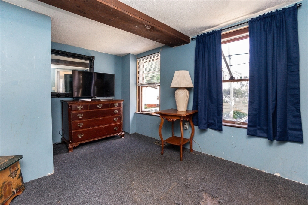 9 Barton Street Salem, MA 01970 - Photo 11 of 26 a living room with furniture and a flat screen tv