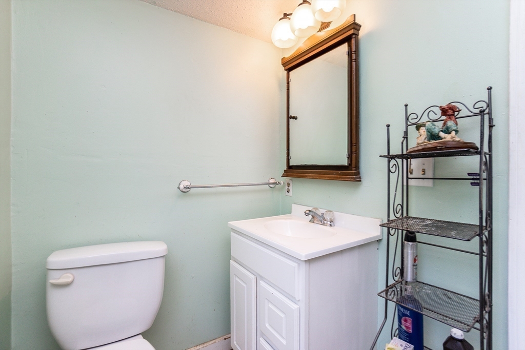9 Barton Street Salem, MA 01970 - Photo 13 of 26 a bathroom with a toilet sink and mirror