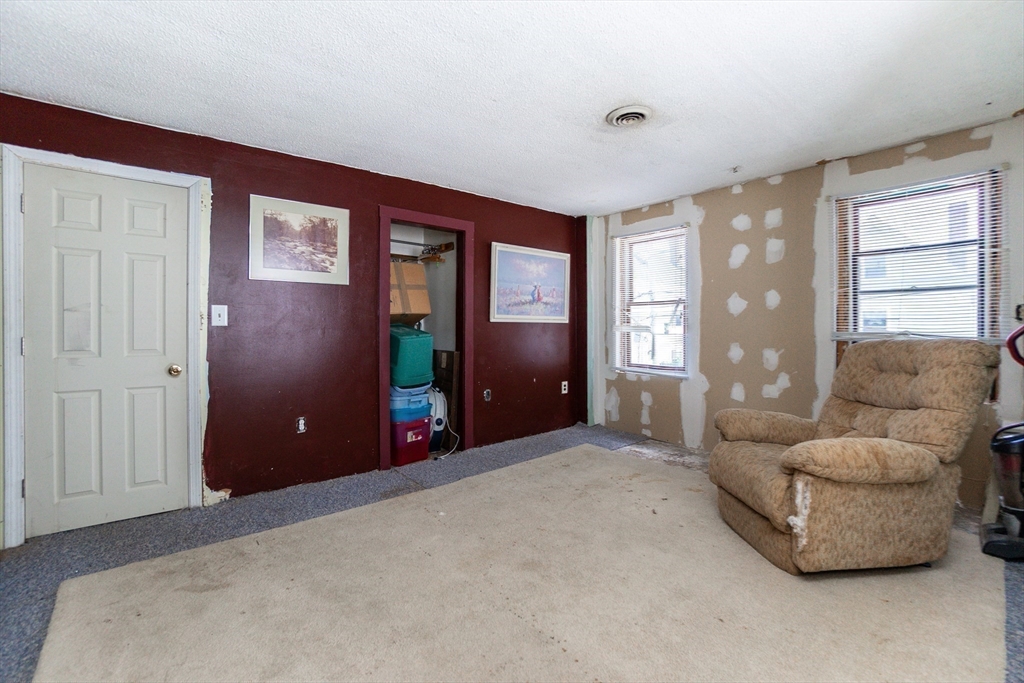 9 Barton Street Salem, MA 01970 - Photo 15 of 26 a living room with furniture and a large window