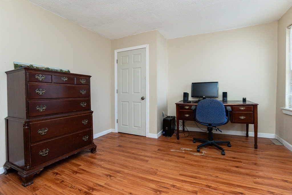 9 Barton Street Salem, MA 01970 - Photo 16 of 26 a view of a workspace with furniture and wooden floor