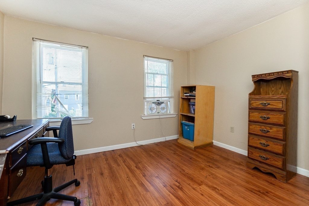 9 Barton Street Salem, MA 01970 - Photo 17 of 26 a view of a workspace with furniture and a window