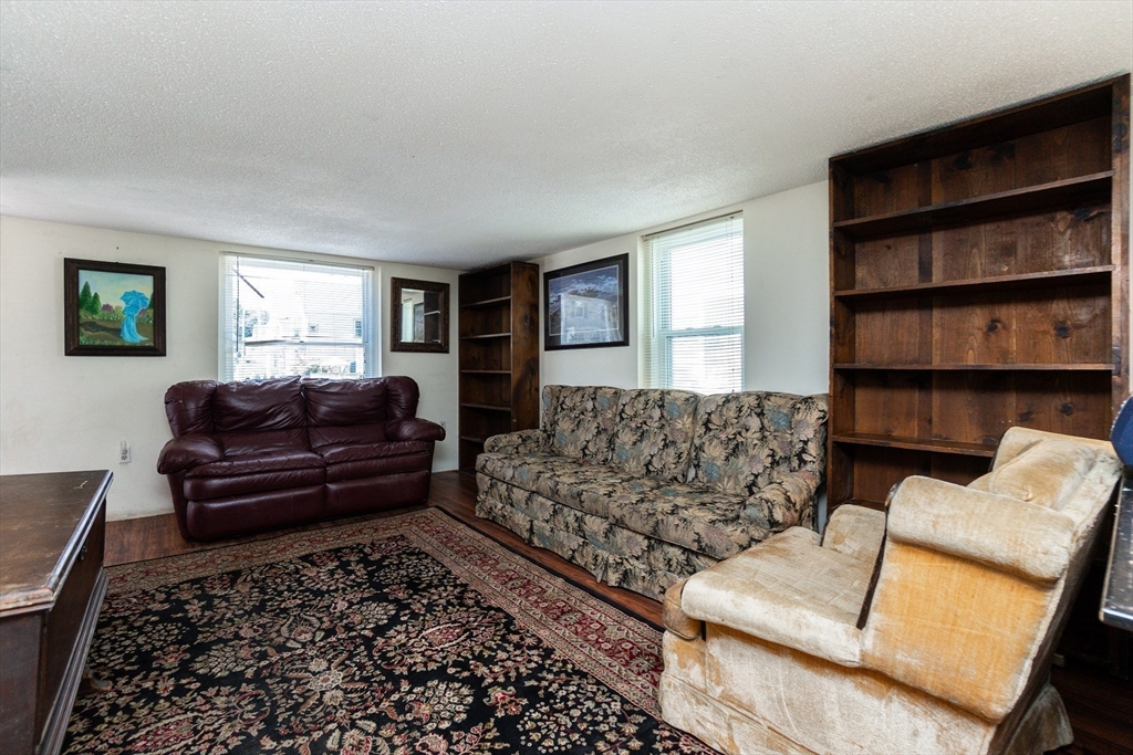 9 Barton Street Salem, MA 01970 - Photo 5 of 26 a living room with furniture and a couch