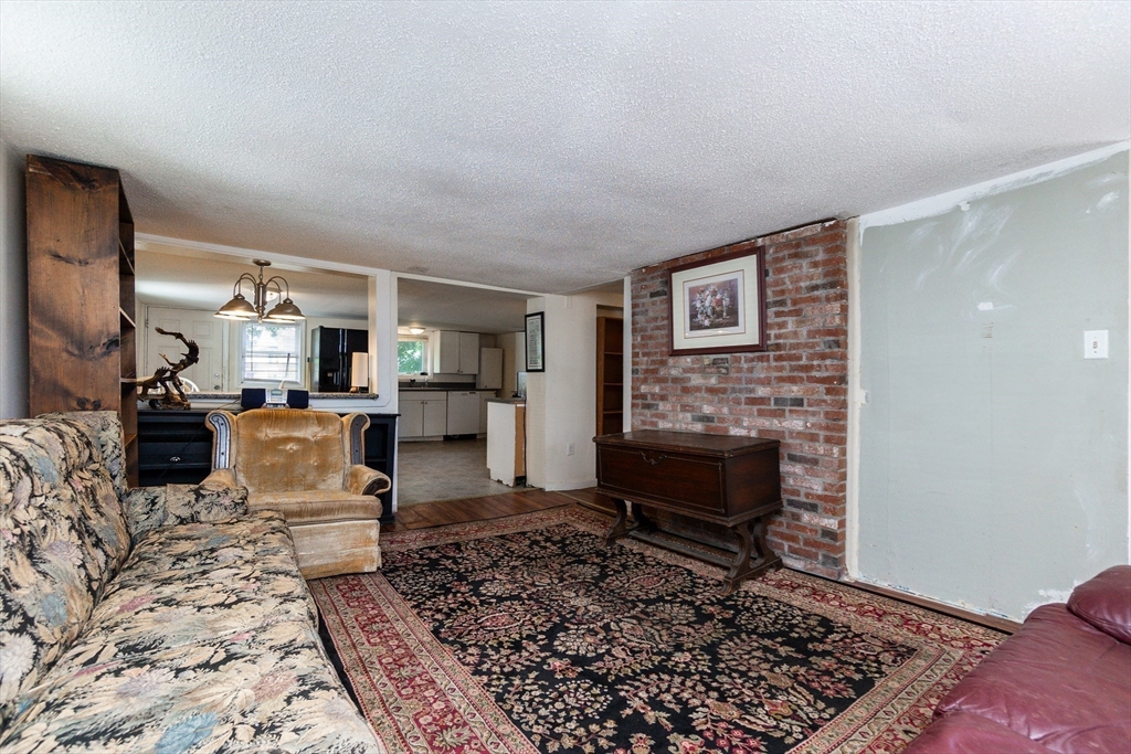 9 Barton Street Salem, MA 01970 - Photo 6 of 26 a living room with furniture and a fireplace