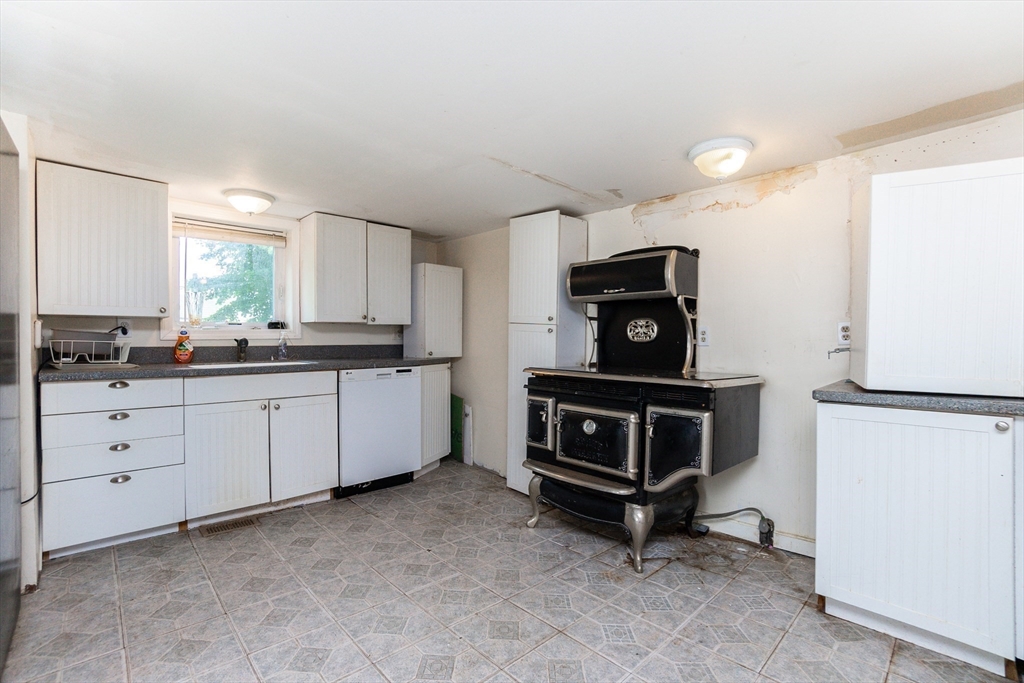 9 Barton Street Salem, MA 01970 - Photo 7 of 26 a kitchen with cabinets and window