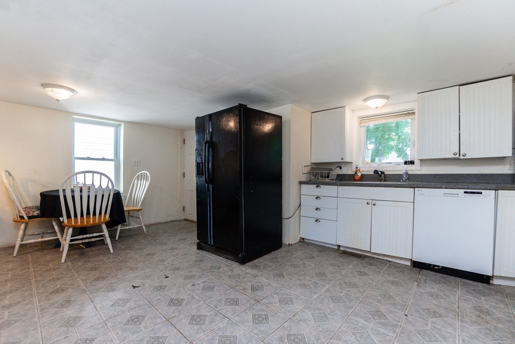 9 Barton Street Salem, MA 01970 - Photo 9 of 26 a kitchen with stainless steel appliances granite countertop a refrigerator and a sink