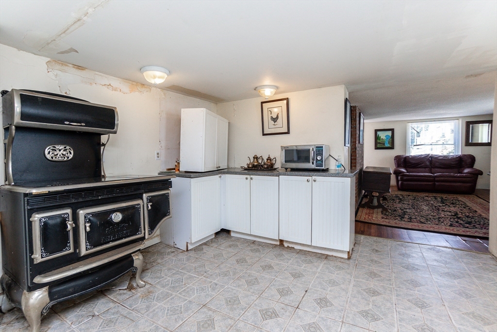 9 Barton Street Salem, MA 01970 - Photo 10 of 26 a kitchen with stainless steel appliances a stove a sink and a microwave