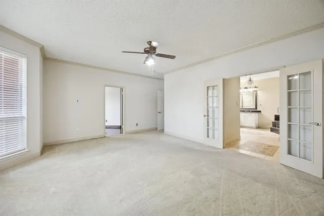 an empty room with fan and entrance