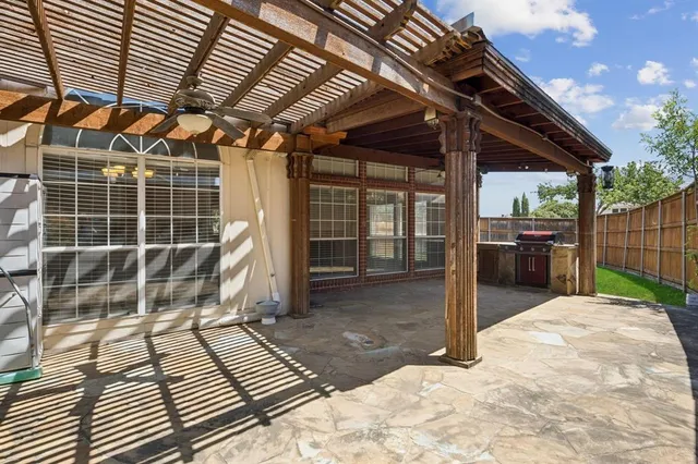 a view of a backyard with wooden floor and roof