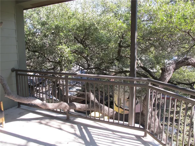 a view of a balcony with wooden floor