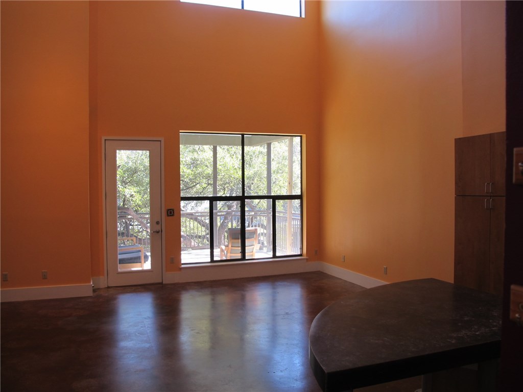 911 Keith Lane, Unit 10 Austin, TX 78705 - Photo 18 of 20 an empty room with wooden floor and windows
