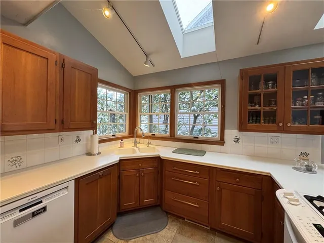 a kitchen with a sink and large window
