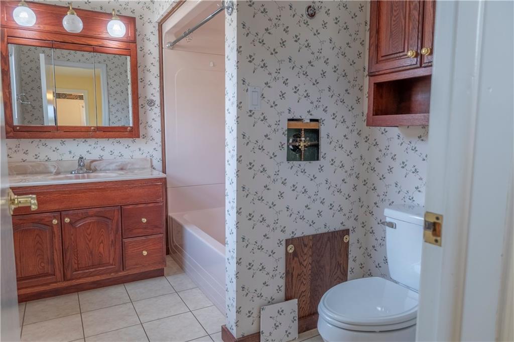 57 Shick Drive Indiana, PA 15701 - Photo 36 of 48 a bathroom with a granite countertop toilet sink and mirror