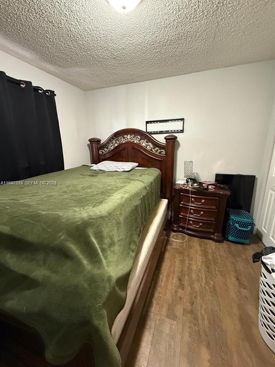5290 West 21st Court, Unit 307 Hialeah, FL 33016 - Photo 16 of 22 a bedroom with a bed and dresser