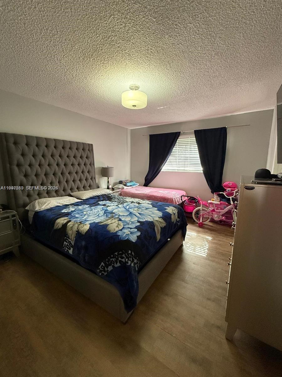 5290 West 21st Court, Unit 307 Hialeah, FL 33016 - Photo 18 of 22 a bedroom with a bed chair and window