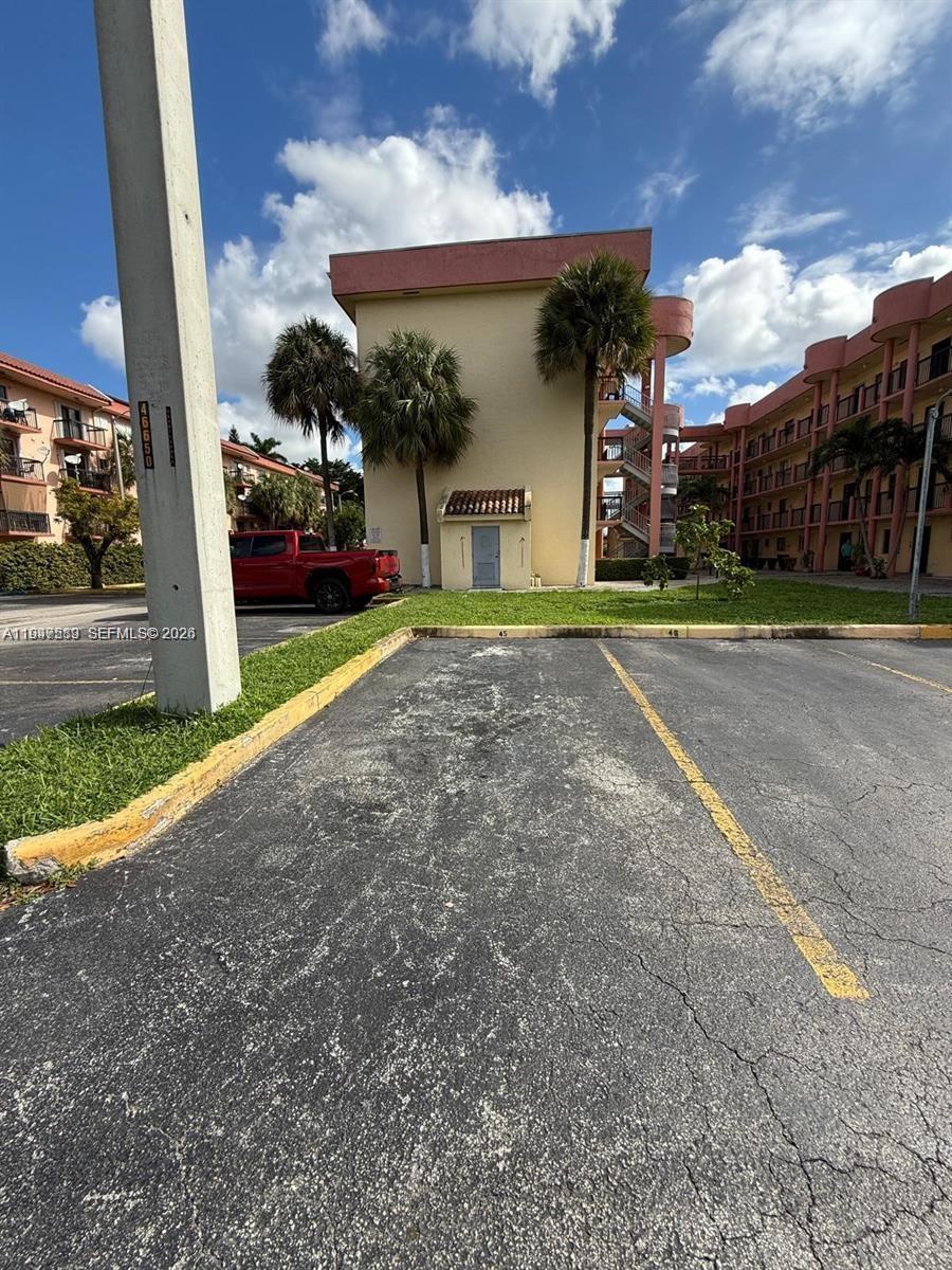 5290 West 21st Court, Unit 307 Hialeah, FL 33016 - Photo 20 of 22 a view of a house with a yard and garage