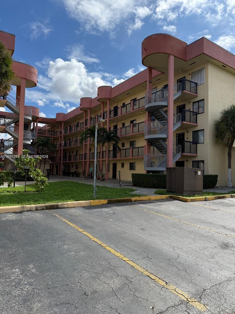 5290 West 21st Court, Unit 307 Hialeah, FL 33016 - Photo 21 of 22 a front view of a building with a street