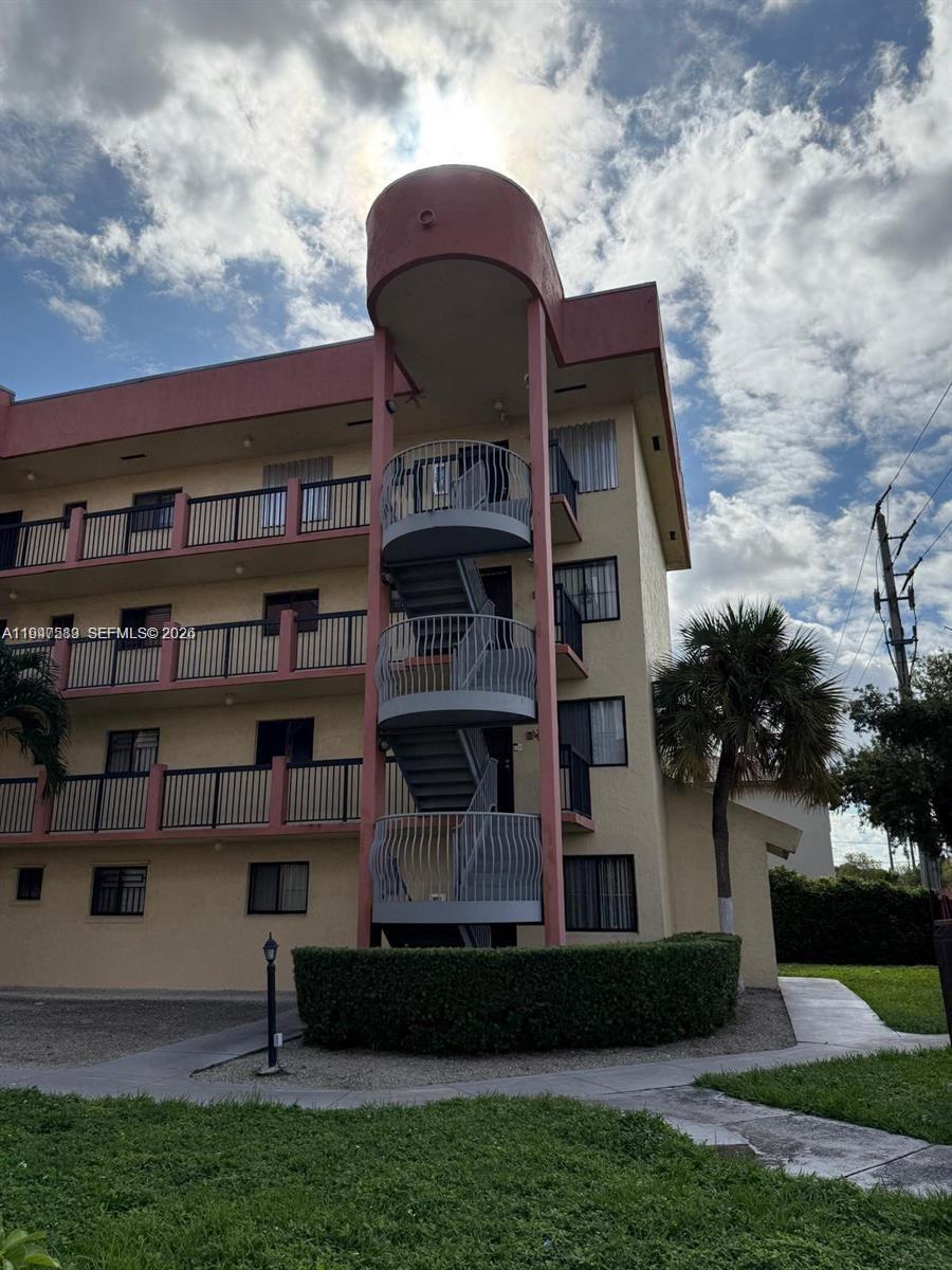 5290 West 21st Court, Unit 307 Hialeah, FL 33016 - Photo 22 of 22 a front view of a house with a yard