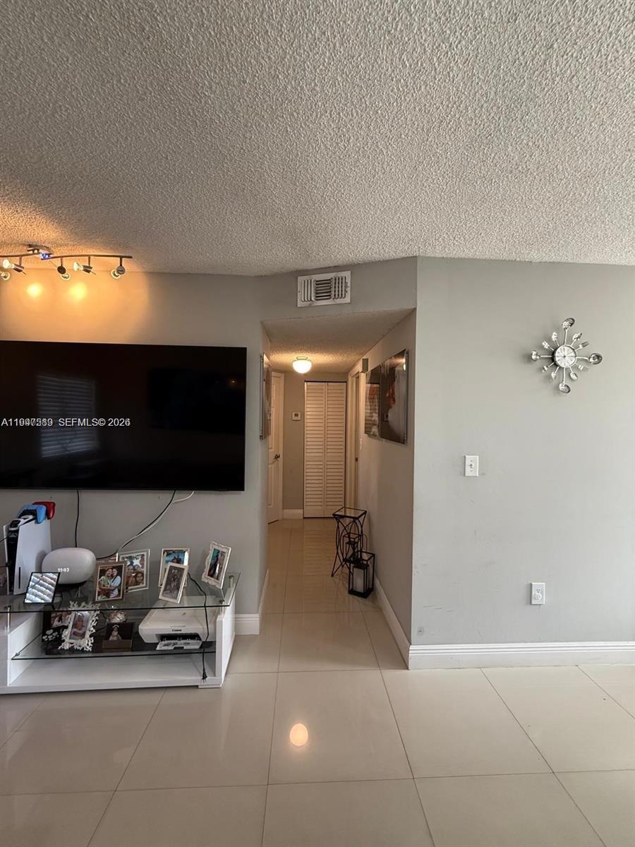 5290 West 21st Court, Unit 307 Hialeah, FL 33016 - Photo 10 of 22 a lobby with furniture and a flat screen tv