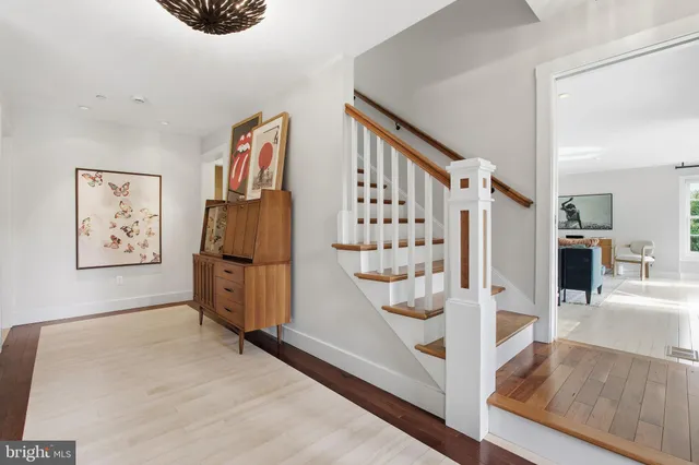 a living room with furniture a view of kitchen and a dining table