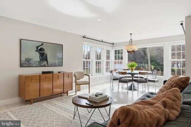 a view of a dining room with furniture large windows and wooden floor