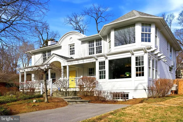a spacious bedroom with a large bed and a chandelier