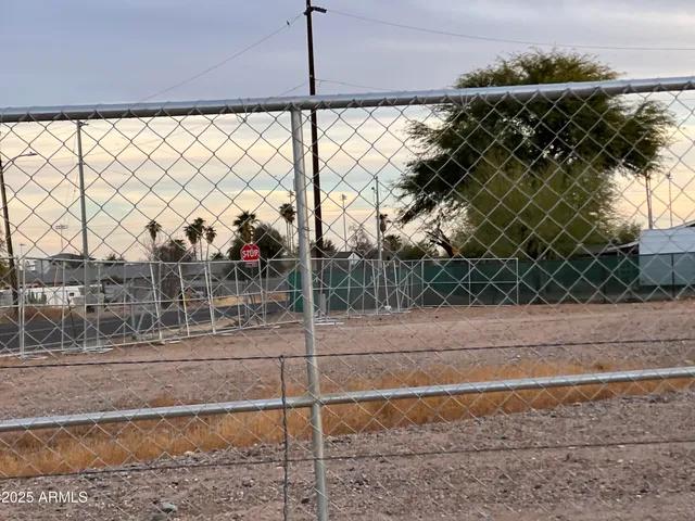 a view of a road and a fence