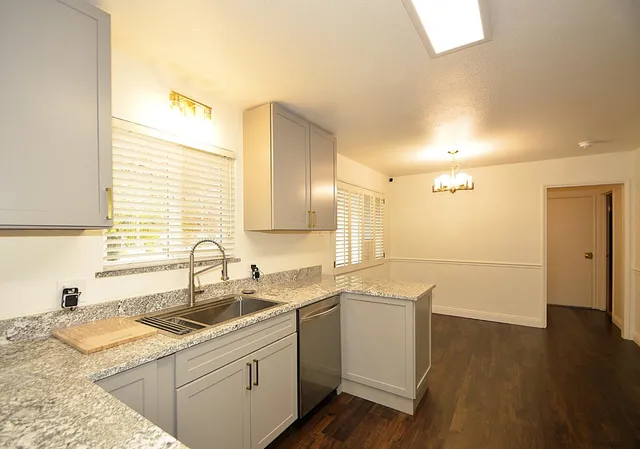 a kitchen with a sink stove and cabinets