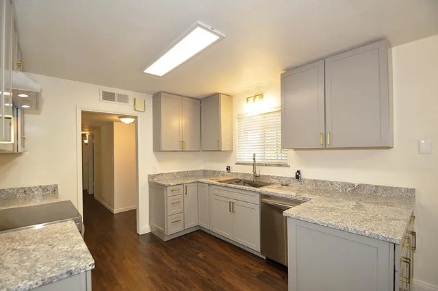 a kitchen with a sink stove and cabinets
