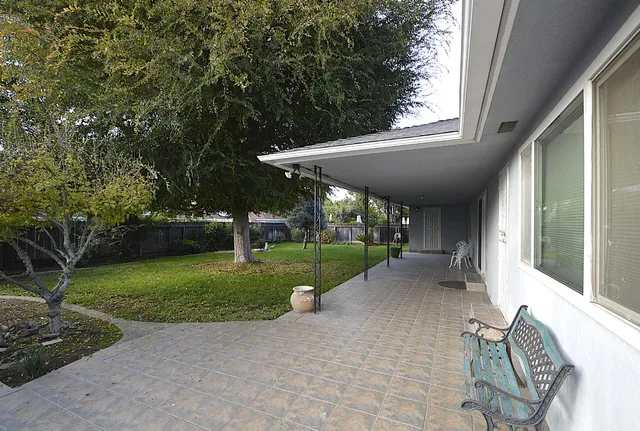 a view of a patio with backyard table and chairs