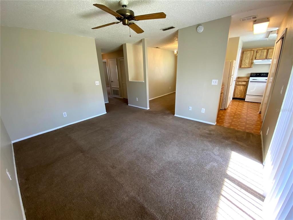 4148 Pershing Pointe Place, Unit 1 Orlando, FL 32822 - Photo 4 of 33 a view of a hallway with a kitchen