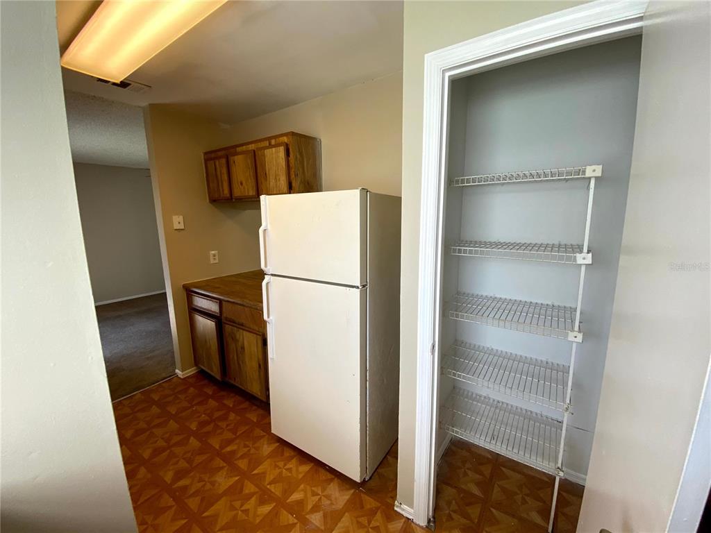 4148 Pershing Pointe Place, Unit 1 Orlando, FL 32822 - Photo 7 of 33 a refrigerator freezer sitting inside of a kitchen