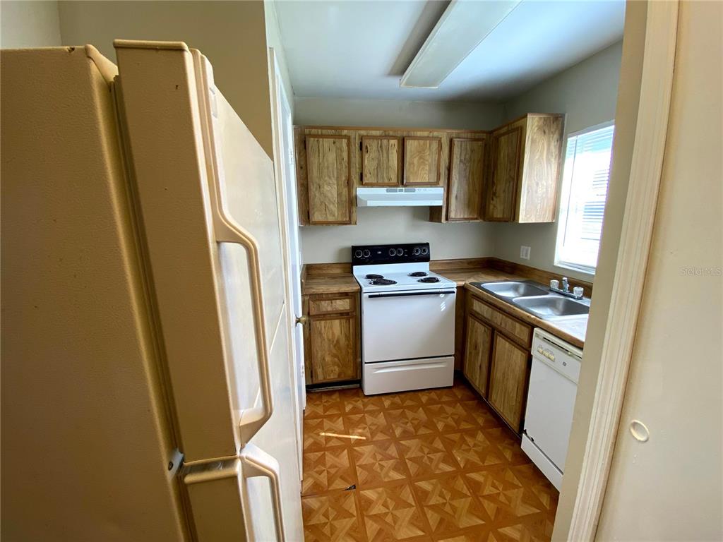 4148 Pershing Pointe Place, Unit 1 Orlando, FL 32822 - Photo 8 of 33 a kitchen with a refrigerator stove and sink
