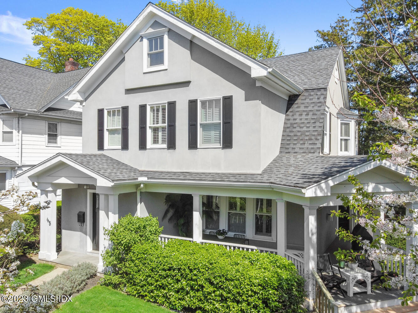 65 Ridge Street Greenwich, CT 06830 - Photo 1 of 35 a front view of a house with a garden and plants