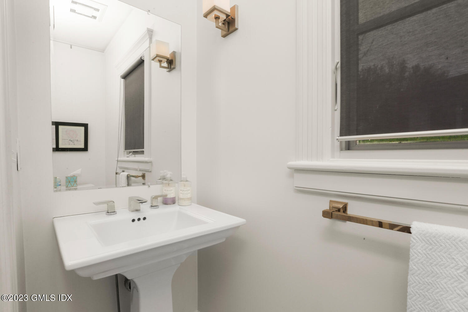 65 Ridge Street Greenwich, CT 06830 - Photo 14 of 35 a bathroom with a sink and a mirror