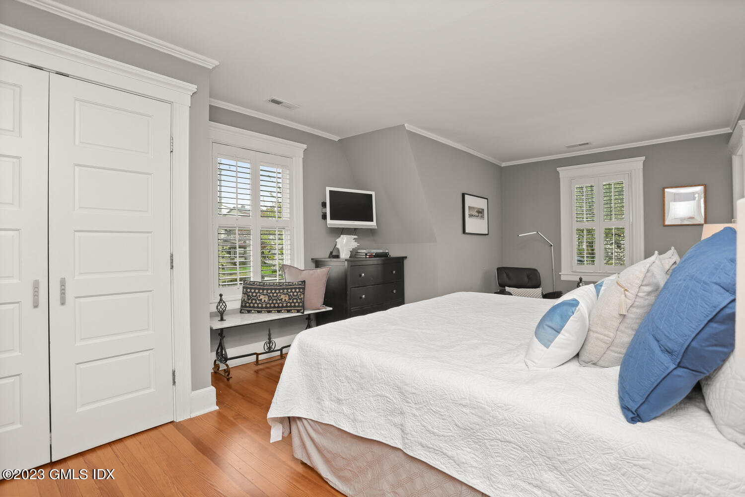 65 Ridge Street Greenwich, CT 06830 - Photo 17 of 35 a bedroom with a bed and wooden floor